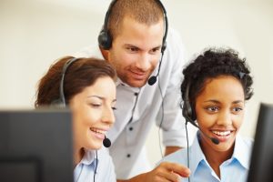 Happy group of call centre employees at work